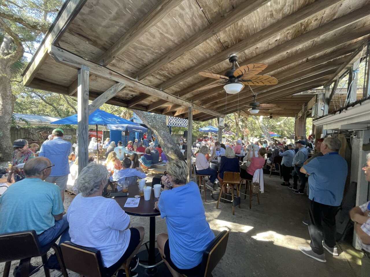 Guests filling the courtyard at The Point Restaurant on Innerarity Point Road in Perdido, Florida