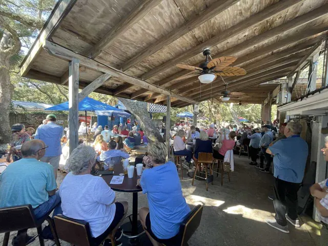 Guests filling the courtyard at The Point Restaurant on Innerarity Point Road in Perdido, Florida