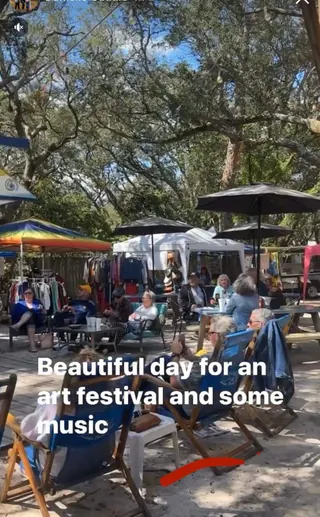Guests relaxing in beach chairs during an art festival in The Courtyard at The Point Restaurant Perdido, FL