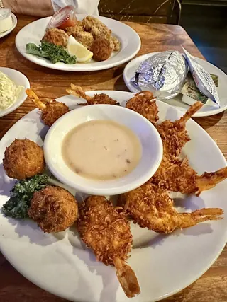 Coconut fried shrimp with hush puppies and dipping sauce at The Point Restaurant Perdido